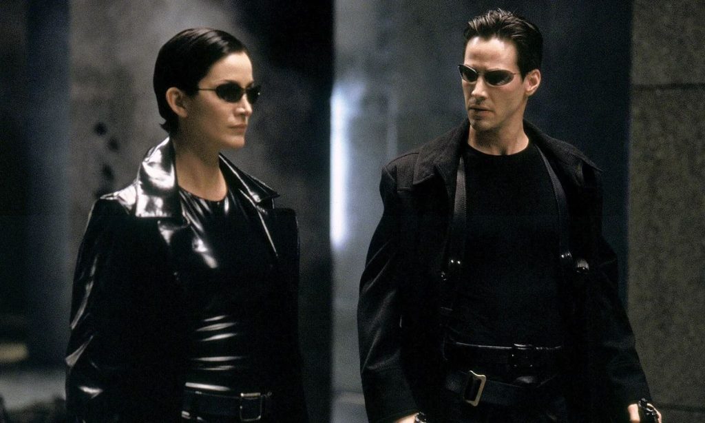 Movies like Ready Player One: The Matrix (1999). Neo and Trinity walk through the streets of the matrix.